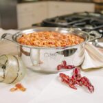 Dish being cooked in steel stockpot wirh 360 Cookware logo visible on the side.