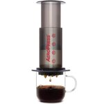 Aeropress being used to fill a glass coffee cup.