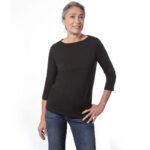 Woman wearing longsleeve black boatnecked shirt