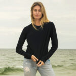 Women at the beach wearing black, longsleeve crew-neck t-shirt