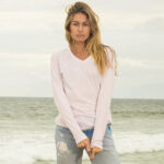 Woman at the beach wearing blush v-neck t-shirt