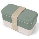 Plastic rectangular lunchbox with soft green upper half, white lower half and beige, broad elastic band.