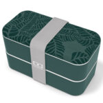 Jungle-green plastic rectangular lunchbox with leaf patterns on the lid and grey, broad elastic band.