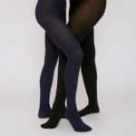 Two pairs of legs showing both black- and blue tinted, slightly transparent tights.