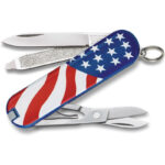 Swiss army knife with scissors, file, carrying ring and American flag printed on the plastic handle.