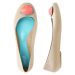 Light beige ballet flats with large, red, gem-shaped button on the tip