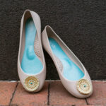 Blush ballet flats with oriental or native American style button on the tip