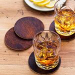 Whiskey glasses standing on leather coasters