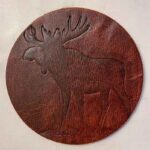 Leather coaster with the shape of a moose stamped on it