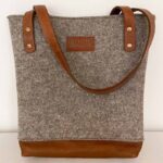 Grey felt bag with 2 leather straps and detailing