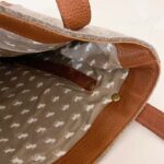 beige lining on inside of bag with white moose patterns