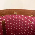 Pink lining on inside of bag with magnet top closure