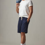 Man wearing navy blue short and white t-shirt.