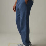 Sideview of blue sweatpants with pockets.