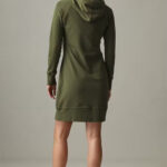 Backview of woman wearing dark green fleece dress with hood.