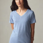 Woman wearing light-blue, short sleeve, v-neck t-shirt.