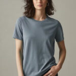 Woman wearing green-grey, short sleeve, crew neck t-shirt.