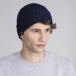 Young man wearing blue beanie hat.