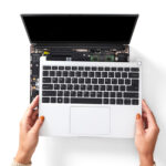 Keyboard being removed from laptop to access other components.