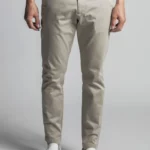 Man wearing beige cotton chino trousers.