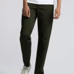 Man wearing khaki green cotton, heavy twill chino trousers.