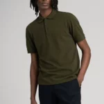 Man wearing short sleeve, dark olive, cotton polo shirt.