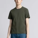 Young man wearing dusty green cotton t-shirt.