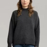 Young woman wearing charcoal melange woolen sweater.