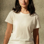 Young woman wearing short sleeve, white cotton t-shirt.