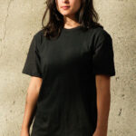 Young woman wearing short sleeve, black cotton t-shirt.