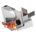 Big electric food slicer slicing meat.