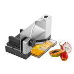 Big electric food slicer slicing peppers and fruit.