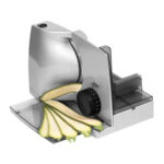 Medium sized electric food slicer slicing zucchini.