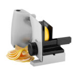 Medium sized electric food slicer slicing oranges.