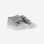 Grey kids' shoes with two velcro straps and white soles.