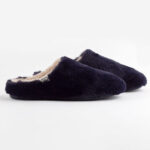 Black women's slip on slippers with white interior.