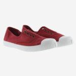 Red women's sneakers with white soles.