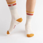 White crew socks with red and orange detailing.