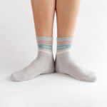 Grey crew socks with blue, white and orange detailing.