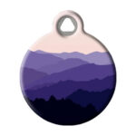 Pet tag with blue mountains depicted on it.